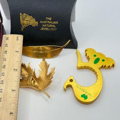 LOT 108: Australian Souvenirs, Heinz Pickle Pin, "Penannular Silver Brooch," Gold Plated Leaf Pins & More