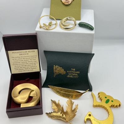 LOT 108: Australian Souvenirs, Heinz Pickle Pin, "Penannular Silver Brooch," Gold Plated Leaf Pins & More