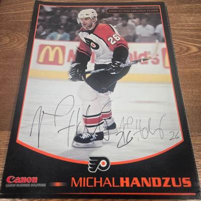 LOT 154: The Philadelphia Flyers at 50 Book, Official Game Program of the 2010 Stanley Cup Final and Players' Signed Photos &...