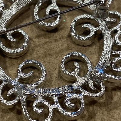 Silver tone brooches including Sarah Cov