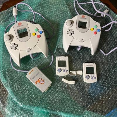 Vintage pair of sega Dreamcast controls with memory packs