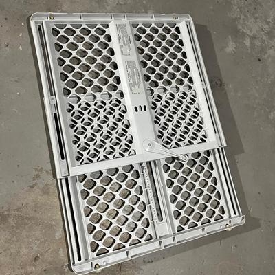 Child safety gate with locking arm