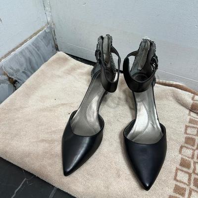 Tahari black ankle-strap heels with a snakeskin-print trim.