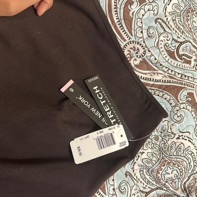 Brown Briggs New York A-line skirt with a pleated hem and a stretch fabric blend.