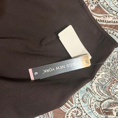 Brown Briggs New York A-line skirt with a pleated hem and a stretch fabric blend.