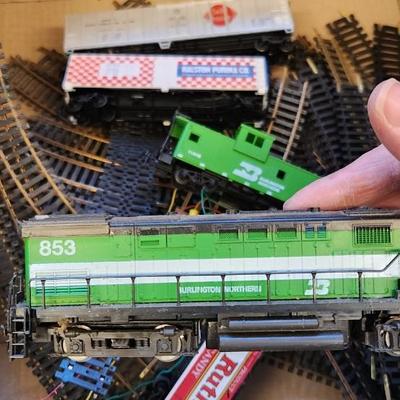 Sale Photo Thumbnail #630: I know very little about trains but this has a Tycoscene in box an over and under set, 4 cars, one engine and a bunch of tracks.