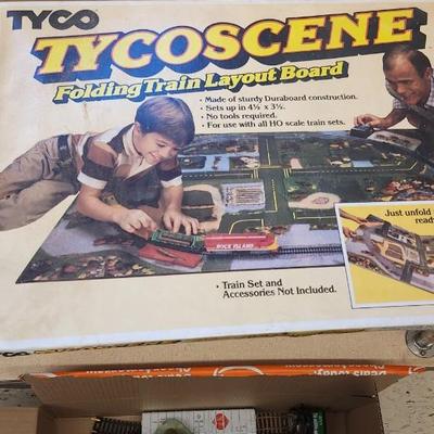 Sale Photo Thumbnail #623: I know very little about trains but this has a Tycoscene in box an over and under set, 4 cars, one engine and a bunch of tracks.