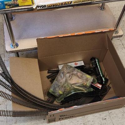 Sale Photo Thumbnail #620: I know very little about trains but this has a Tycoscene in box an over and under set, 4 cars, one engine and a bunch of tracks.