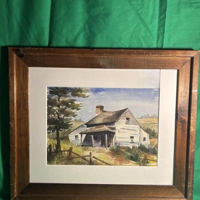 Sale Photo Thumbnail #12: Framed watercolor painting depicting a rural house surrounded by trees and a fence in a countryside setting. The painting is placed within a wooden frame and a white mat. The artwork captures a serene scene with a focus on natural elements and architectur