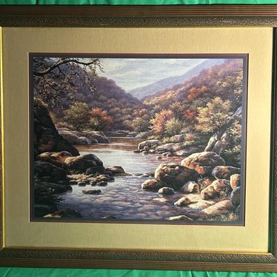 Sale Photo Thumbnail #58: Framed landscape artwork depicting a mountain stream surrounded by rocks and vibrant foliage. Features a double-matted border and an ornate, textured gold-tone frame. The piece is in ready-to-display condition, with no visible damage to the frame, glass, 