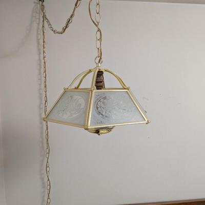 Hanging light with electric cord, and long chain.