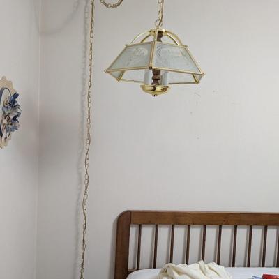 Hanging light with electric cord, and long chain.