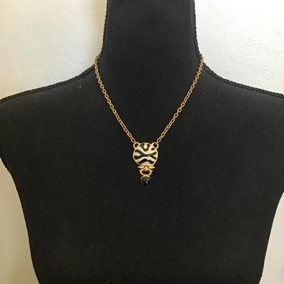 Very nice gold toned, black and white enamel pendant necklace