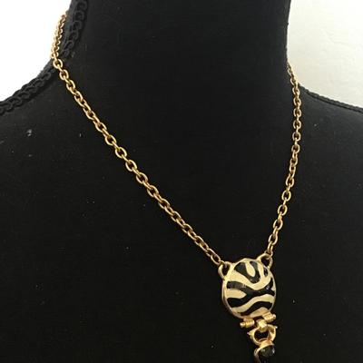 Very nice gold toned, black and white enamel pendant necklace