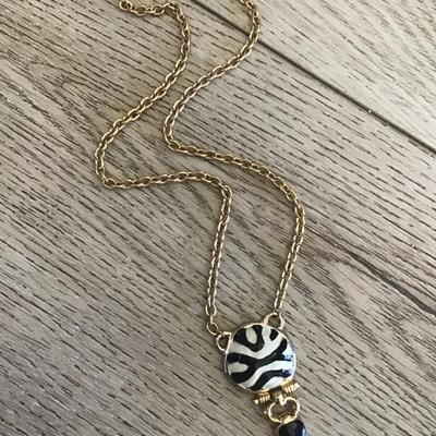 Very nice gold toned, black and white enamel pendant necklace