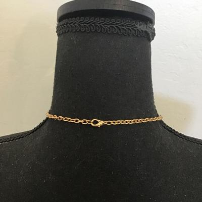 Very nice gold toned, black and white enamel pendant necklace