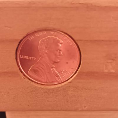 HAND CRAFTED WOODEN TOYS WITH AN EMBEDDED PENNY FOR THE YEAR THEY WERE MADE