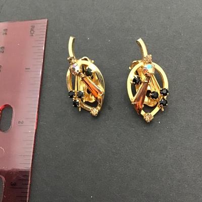 Sale Photo Thumbnail #117: Beautiful vintage, gold tone Austria signed AB rhinestone clip on earrings Please see attached photos.