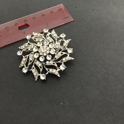 Sale Photo Thumbnail #126: Silvertone clear rhinestone brooch. Please see attached photos.