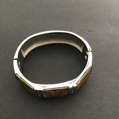 Sale Photo Thumbnail #172: Silvertone hinged bangle bracelet with honey Baltic amber inserts. Please see attached photos.