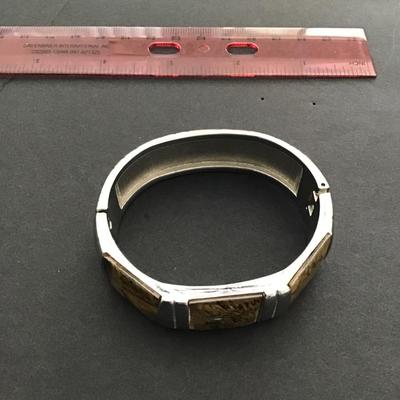 Sale Photo Thumbnail #173: Silvertone hinged bangle bracelet with honey Baltic amber inserts. Please see attached photos.