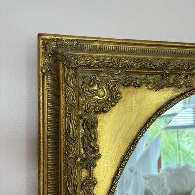 Sale Photo Thumbnail #118: Bombay Co. gold spandrel mirror; approx. 30" x 26"; overall good condition, minor loss top back right corner of frame;