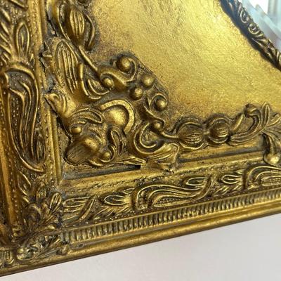 Sale Photo Thumbnail #120: Bombay Co. gold spandrel mirror; approx. 30" x 26"; overall good condition, minor loss top back right corner of frame;