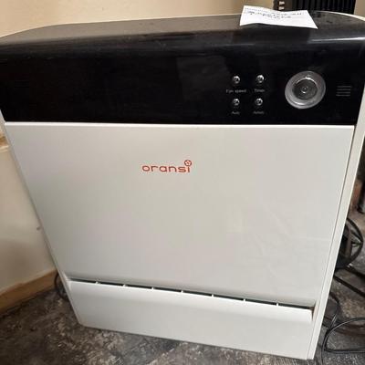 Two heaters and a tower fan