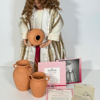 LOT 95: Jesus Water into Wine Doll by Ashton-Drake Galleries w/ Pots & COA