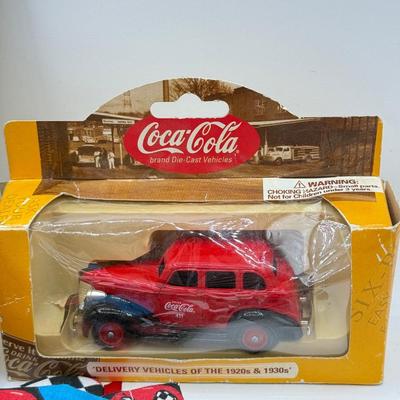 LOT 116: Coca Cola Collection: Matchbox Cars, Santa Playing Cards & NASCAR Fabric