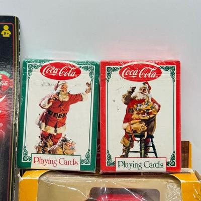 LOT 116: Coca Cola Collection: Matchbox Cars, Santa Playing Cards & NASCAR Fabric
