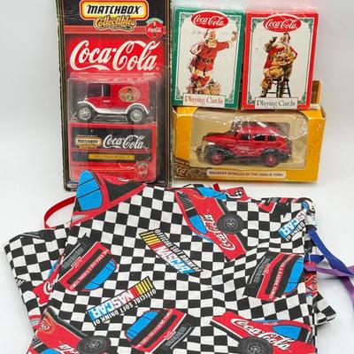 LOT 116: Coca Cola Collection: Matchbox Cars, Santa Playing Cards & NASCAR Fabric