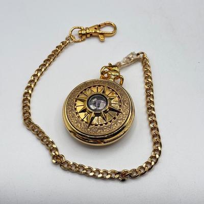 LOT 120: Franklin Mint Chocolate El Cazador Pocket Watch, Coastal Navigation & Piloting Guides