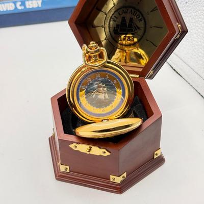 LOT 120: Franklin Mint Chocolate El Cazador Pocket Watch, Coastal Navigation & Piloting Guides