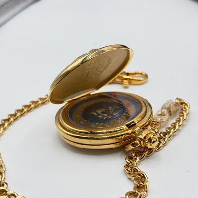 LOT 120: Franklin Mint Chocolate El Cazador Pocket Watch, Coastal Navigation & Piloting Guides