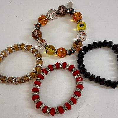 Sale Photo Thumbnail #44: Lot of four stretch-style bracelets, all in good condition.