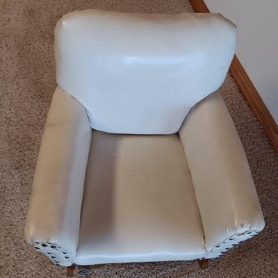 A CHILD'S VINYL UPHOLSTERED ROCKING CHAIR