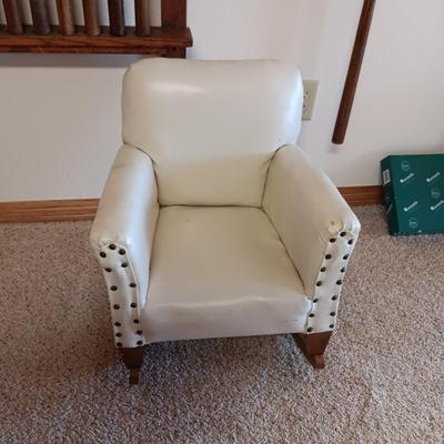 A CHILD'S VINYL UPHOLSTERED ROCKING CHAIR