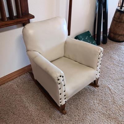 A CHILD'S VINYL UPHOLSTERED ROCKING CHAIR