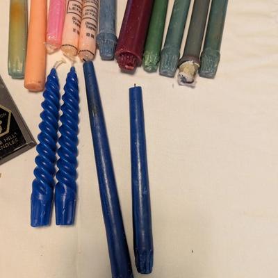 Large group of candles in multiple colors.