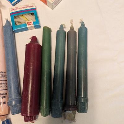 Large group of candles in multiple colors.