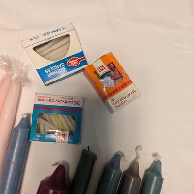 Large group of candles in multiple colors.