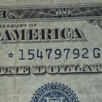 Sale Photo Thumbnail #38: 1935G $1 Silver Certificate STAR NOTE. no "IN GOD WE TRUST" on Back. This bill is in fair condition