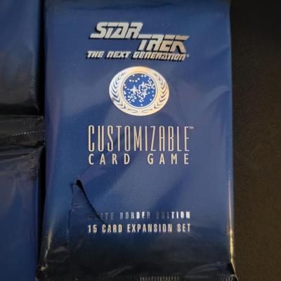 Sale Photo Thumbnail #140: Star Trek Customizable Card Game White Border Edition 15 Card Expansion Set (One set does have a tear as pictured)