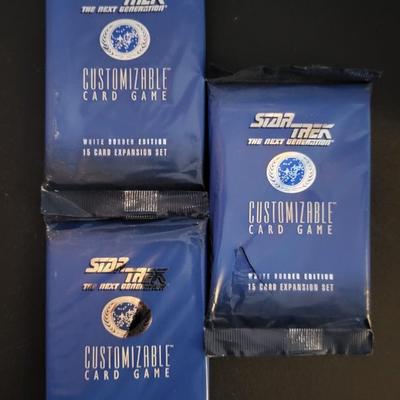 Sale Photo Thumbnail #139: Star Trek Customizable Card Game White Border Edition 15 Card Expansion Set (One set does have a tear as pictured)