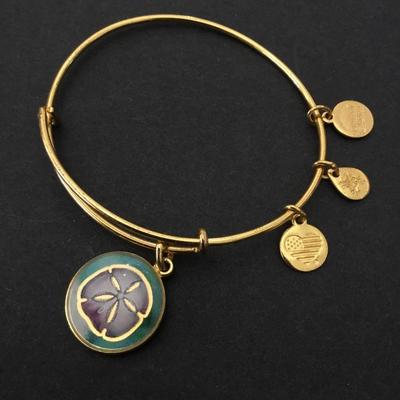 Alex and Ani‘s gold tone Sand Dollar charm bracelet