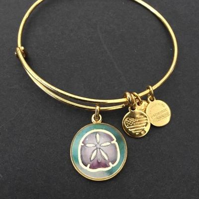 Alex and Ani‘s gold tone Sand Dollar charm bracelet