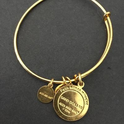 Alex and Ani‘s gold tone Sand Dollar charm bracelet
