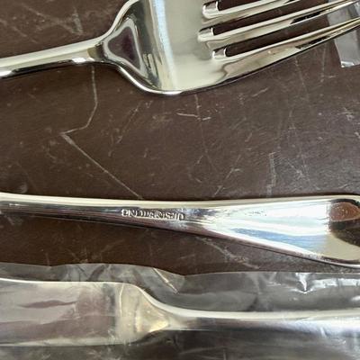 Sale Photo Thumbnail #91: In mostly unused condition and still in their packages. Qty: 5 Serving Pieces, 12 small forks, 12 big forks, 11 small spoons (missing 1) , 12 big spoons, land 12 knives.