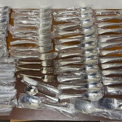 Sale Photo Thumbnail #92: In mostly unused condition and still in their packages. Qty: 5 Serving Pieces, 12 small forks, 12 big forks, 11 small spoons (missing 1) , 12 big spoons, land 12 knives.